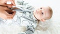 Baby cute child banner. Happy cute baby kid girl lying on white bed background. Light background. Little child. Serious Royalty Free Stock Photo