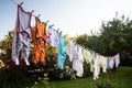 Baby cute clothes hanging on the clothesline outdoor. Child laundry hanging on line in garden Royalty Free Stock Photo