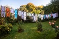 Baby cute clothes hanging on the clothesline outdoor. Child laundry hanging on line in garden Royalty Free Stock Photo