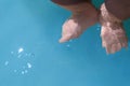 Baby Dangles Feet in Water Royalty Free Stock Photo