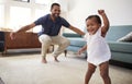 Baby Daughter Dancing With Father In Lounge At Home Royalty Free Stock Photo