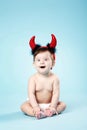 Baby with devil horns on blue background Royalty Free Stock Photo
