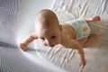 Baby in a diaper in playpen Royalty Free Stock Photo