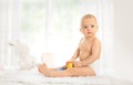 Baby in diaper with rubber toy Royalty Free Stock Photo