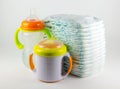 Baby diapers and bottles on a white background Royalty Free Stock Photo