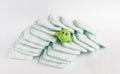 Baby diapers on a white background and a children`s toy frog Royalty Free Stock Photo