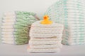 Baby diapers on a white background close-up and copy space. Accessories for a newborn diapers, pacifier, bottles, teether, ducks f Royalty Free Stock Photo