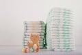 Baby diapers on a white background close-up and copy space. Accessories for a newborn diapers, pacifier, bottles, teether, ducks f Royalty Free Stock Photo