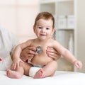 Baby at the doctor getting breath check up with stethoscope