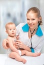 Baby and doctor pediatrician. doctor listens to the heart with s