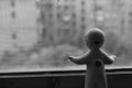 Baby-doll looking out of the window (backside)