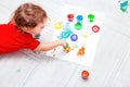 Baby drawing multi-colored finger paints. Flat lay. Prescool developing