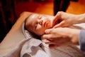 The baby dress up in clothes on the table in the Church. ordinance of baptism.