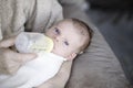 Baby drinking from bottle with nipple in mouth Royalty Free Stock Photo