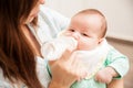 Baby drinking formula from a bottle Royalty Free Stock Photo