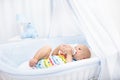 Baby drinking milk. Boy with formula bottle in bed Royalty Free Stock Photo