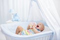 Baby drinking milk. Boy with formula bottle in bed Royalty Free Stock Photo