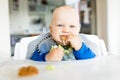 Baby boy eating with BLW method, baby led weaning Royalty Free Stock Photo