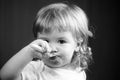 Baby eating with dirty face. Cheerful smiling child child eats itself with a spoon Baby eating with dirty face. Smiling Royalty Free Stock Photo