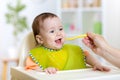 Baby eating food on kitchen Royalty Free Stock Photo