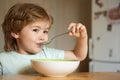 Baby eating food on kitchen. Happy child. Cute kid are eating. Little baby are eating. Little boy having breakfast in