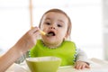 Baby eating food with mother help Royalty Free Stock Photo