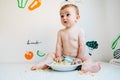 Baby eating by himself learning through the Baby-led Weaning method, exploring the flavors of food with curiosity Royalty Free Stock Photo