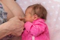 Baby eating mother`s milk. Mother breastfeeding baby. Concept of lactation infant. The baby girl is 15 days old Royalty Free Stock Photo