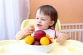 Baby eating peaches and apricotes