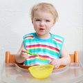 Baby eating porridge from bowl Royalty Free Stock Photo