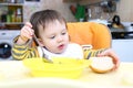 Baby eating soup and bread Royalty Free Stock Photo