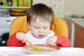 Baby eating soup on kitchen Royalty Free Stock Photo
