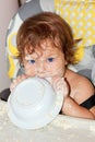 Baby eating yogurt and soiled face Royalty Free Stock Photo