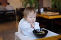 Baby eats the chinese noodles at restaurant