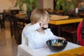 Baby eats the chinese noodles at restaurant