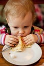 Baby eats the delicious pancakes Royalty Free Stock Photo