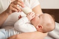 baby eats milk from a bottle