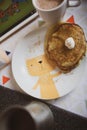 The baby eats pancakes with sour cream and cocoa. Royalty Free Stock Photo