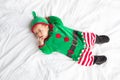 Baby In Elf Costume For Christmas Holiday On White