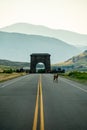 Baby Elk Crossing Empty Road Leading To Roosevelt Arch Royalty Free Stock Photo