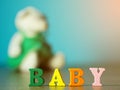 Baby. English alphabet made of wooden letter color. Alphabet baby on wooden table and Little Bear