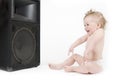 Baby enjoying sound in front of loudspeaker