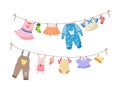 Baby fabric apparel. Baby girls and boys clothes hanging on clothesline. Drying children clothes and accessories after washing Royalty Free Stock Photo