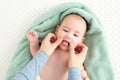 Baby face massage background. Mother gently stroking baby boy face with both hands. Close up cropped shot. Royalty Free Stock Photo