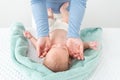 Baby face massage concept. Masseuse or mother gently stroking baby boy face with both hands. Close up cropped shot. Royalty Free Stock Photo