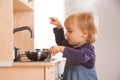 Baby family girl daughter play cooking in toy kitchen Royalty Free Stock Photo