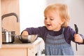Baby family girl daughter play cooking in toy kitchen Royalty Free Stock Photo