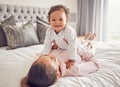 Baby, family and love with a mother and her girl bonding on bed in the bedroom of their home together. Children, parent Royalty Free Stock Photo