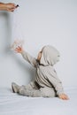 Baby fashion. Unisex clothes for babies. Cute baby in cotton set suit on light background.