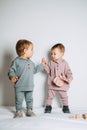 Baby fashion. Unisex clothes for babies. Two Cute baby girls or boys in cotton set